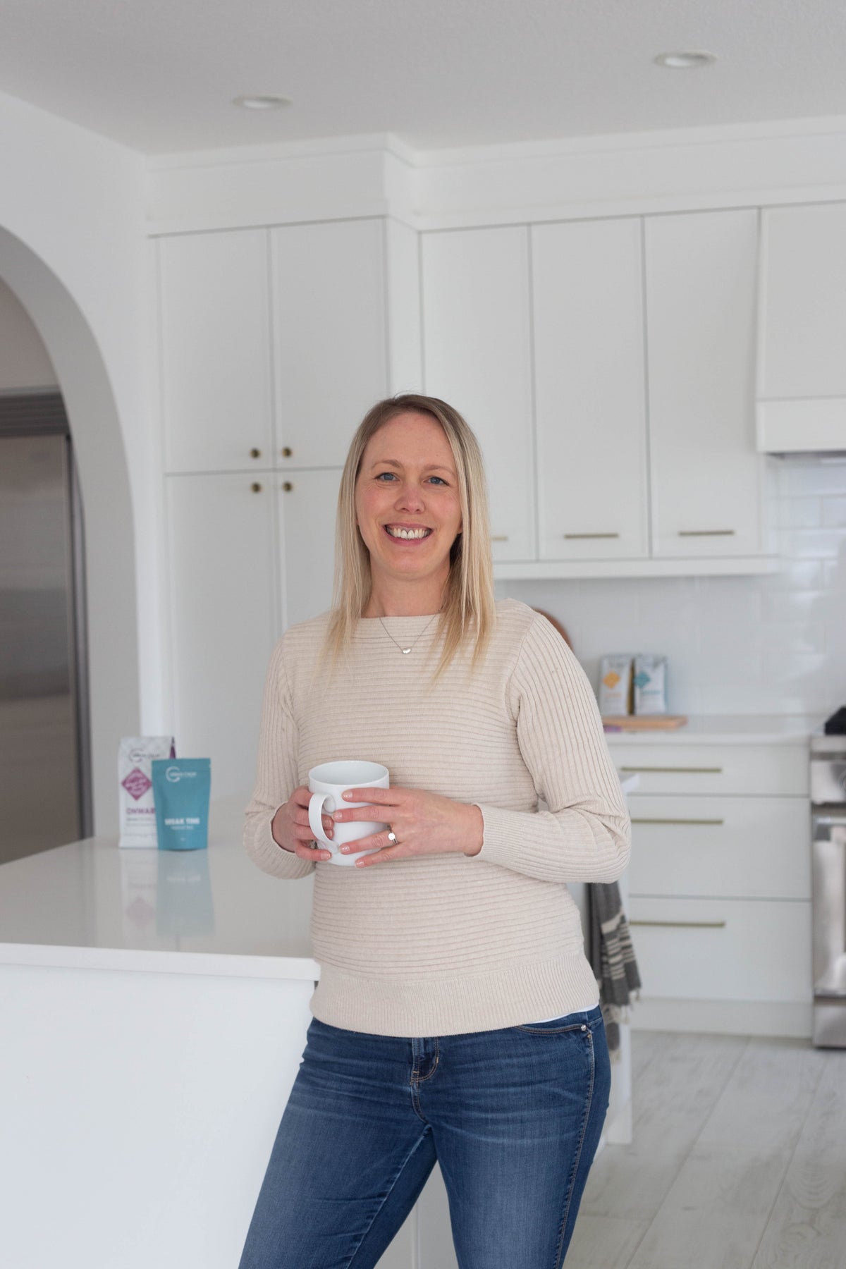 Tara Duncan, founder of Urban Calm Coffee, holding a coffee mug