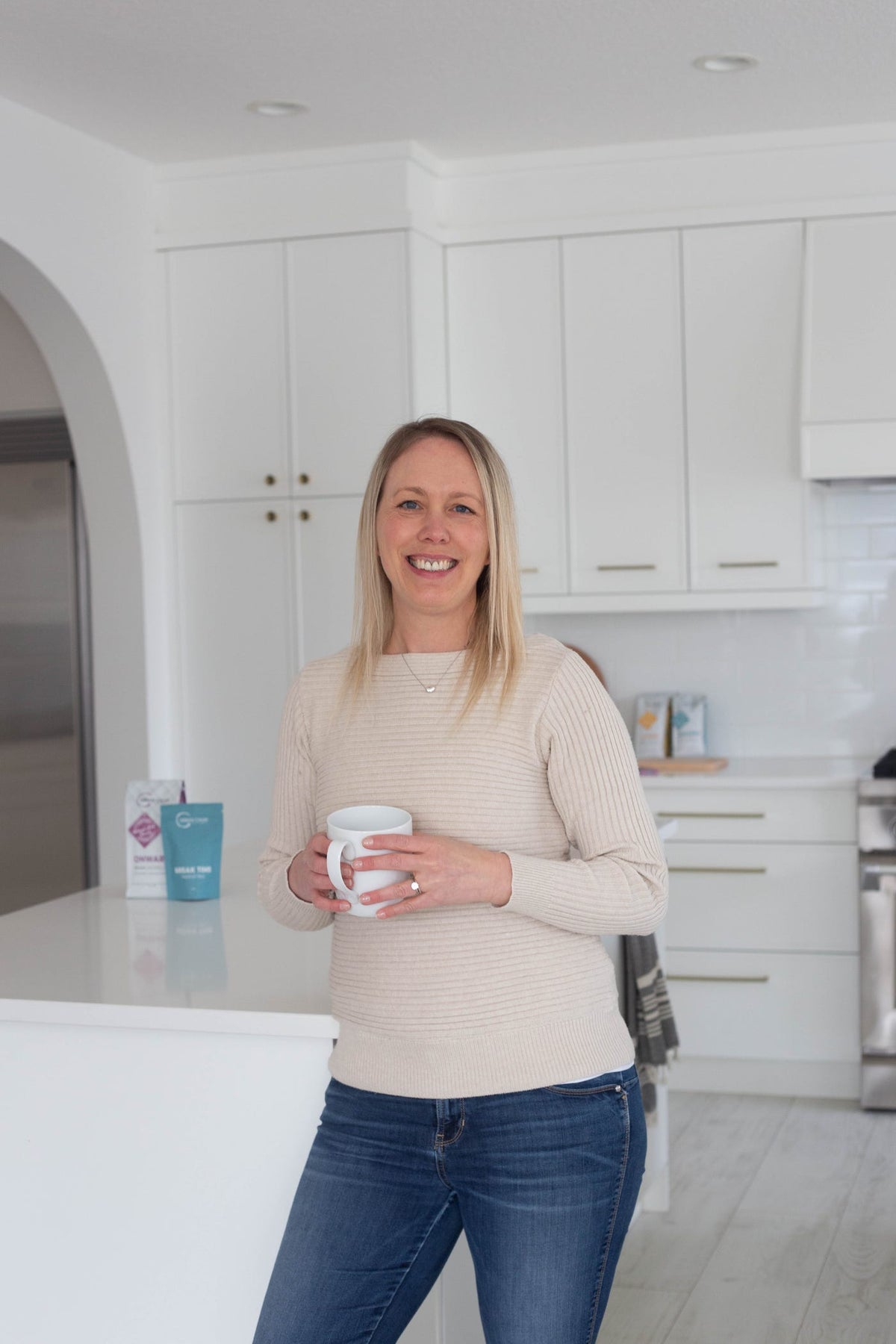 Tara Duncan, founder of Urban Calm Coffee, holding a coffee mug
