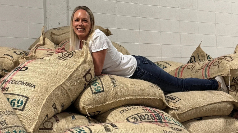 Urban Calm founder Tara Duncan with Colombian green coffee sacks from Huila