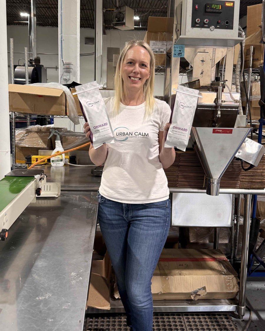 Urban Calm founder Tara Duncan with coffee bags in the Calgary roastery