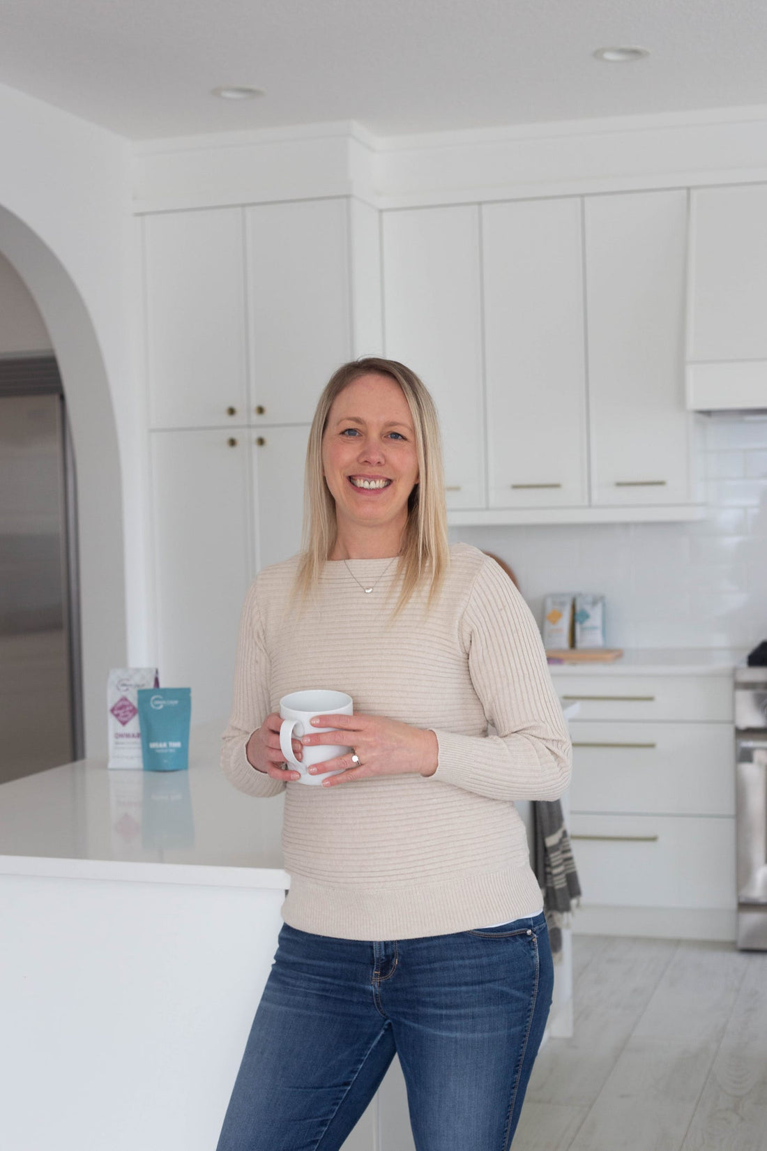 Tara Duncan, founder of Urban Calm Coffee, holding a coffee mug