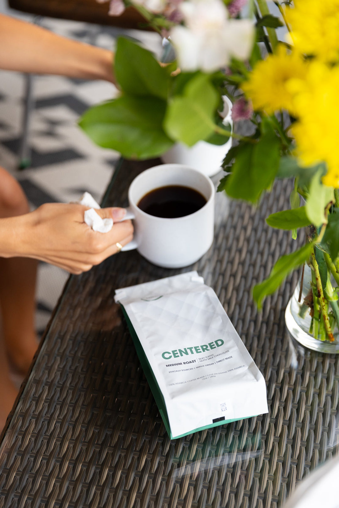 Centered medium roast regular coffee bag beside a freshly brewed cup