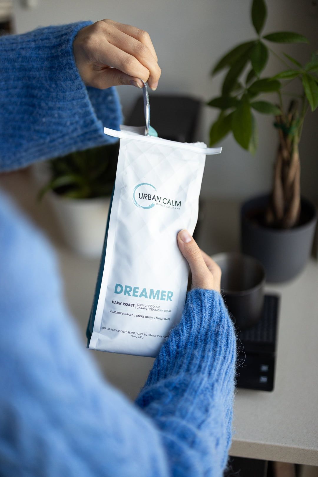 Opening a bag of Dreamer dark roast regular coffee before brewing