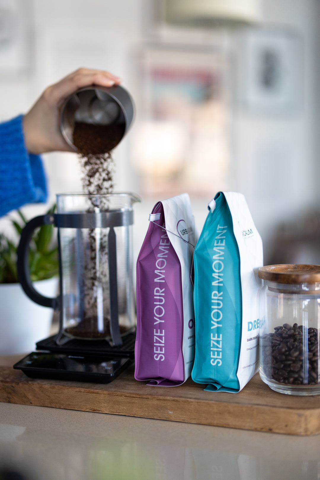 Urban Calm regular coffee being measured into a French press